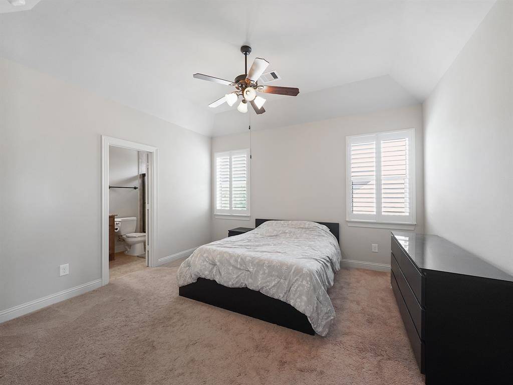 Secondary bedroom with vaulted ceiling, plantation shutters and private ensuite bathroom!