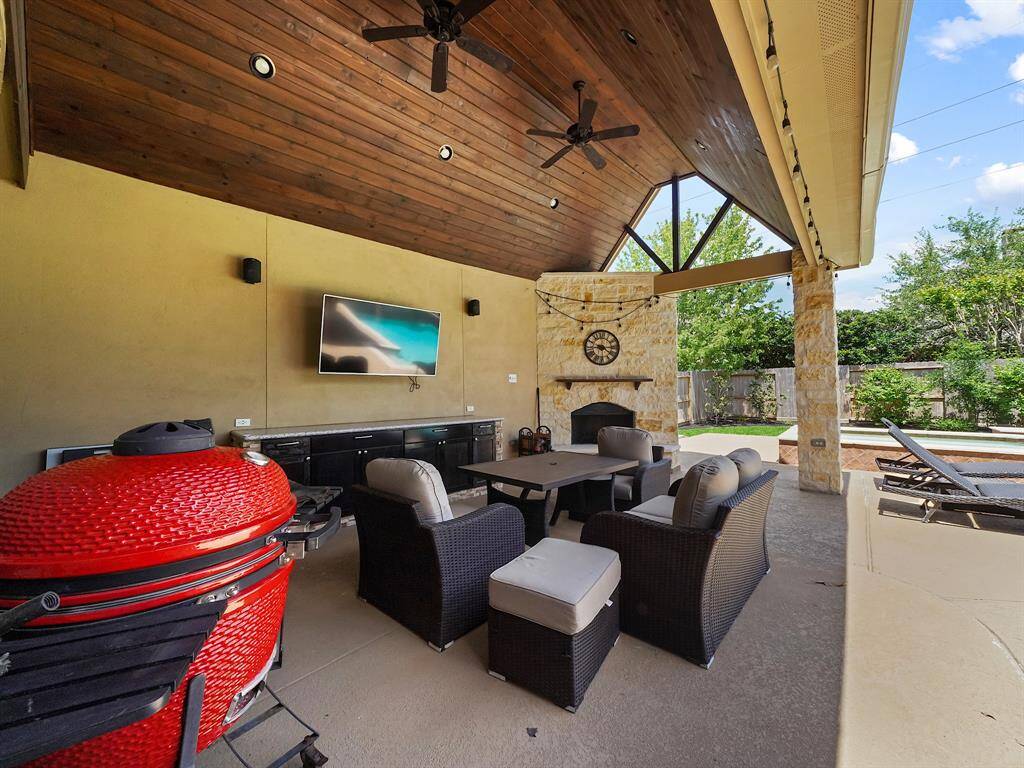 Boasting an immaculate outdoor retreat, this home features an expansive covered patio perfect for entertaining or relaxing. Enjoy cozy evenings by the fireplace, complete with space for a TV, creating the ultimate outdoor living experience.