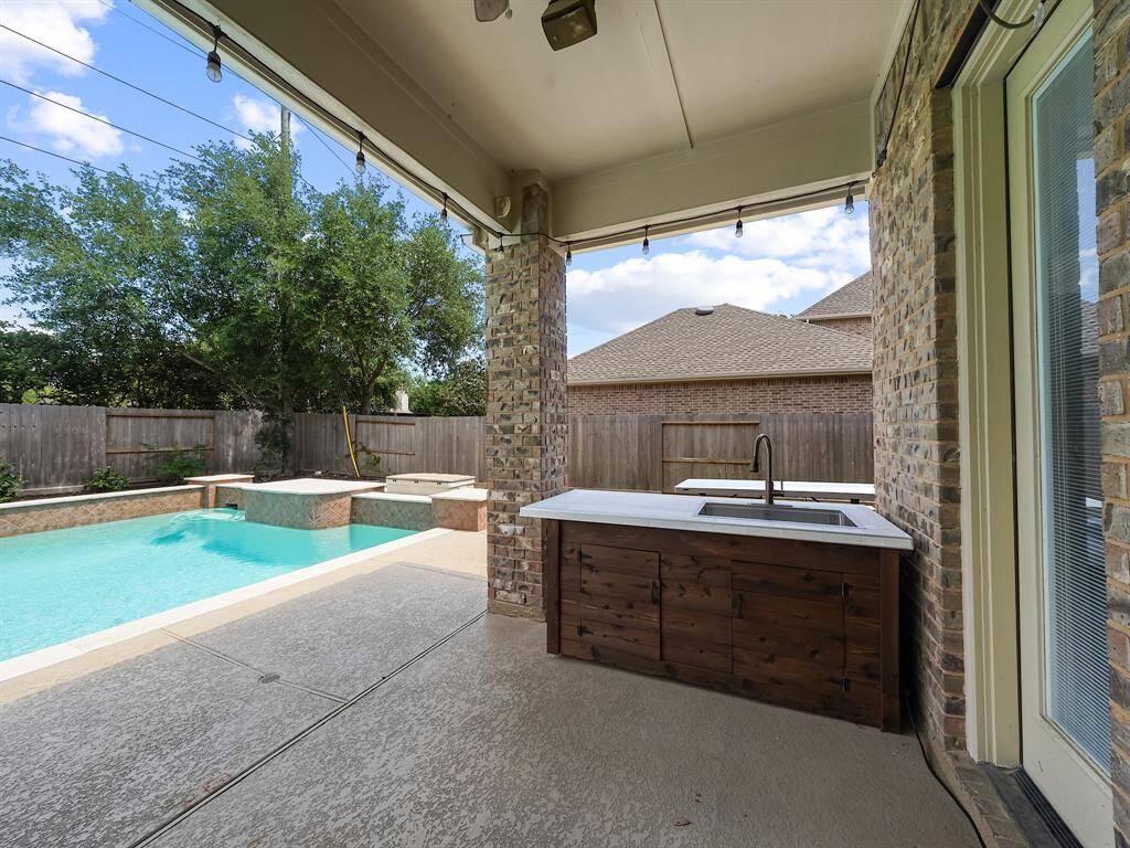 The property offers an incredible outdoor entertainment space with a second covered patio. This area includes a fantastic outdoor wet bar complete with sink!