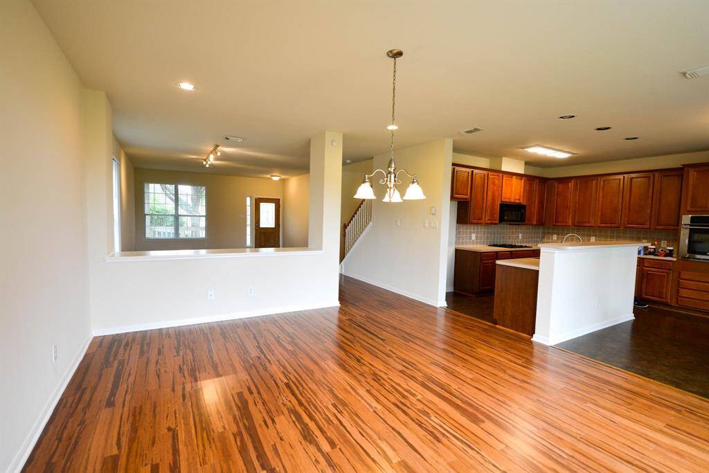 This spacious and bright downstairs area offers an inviting open layout filled with natural light.