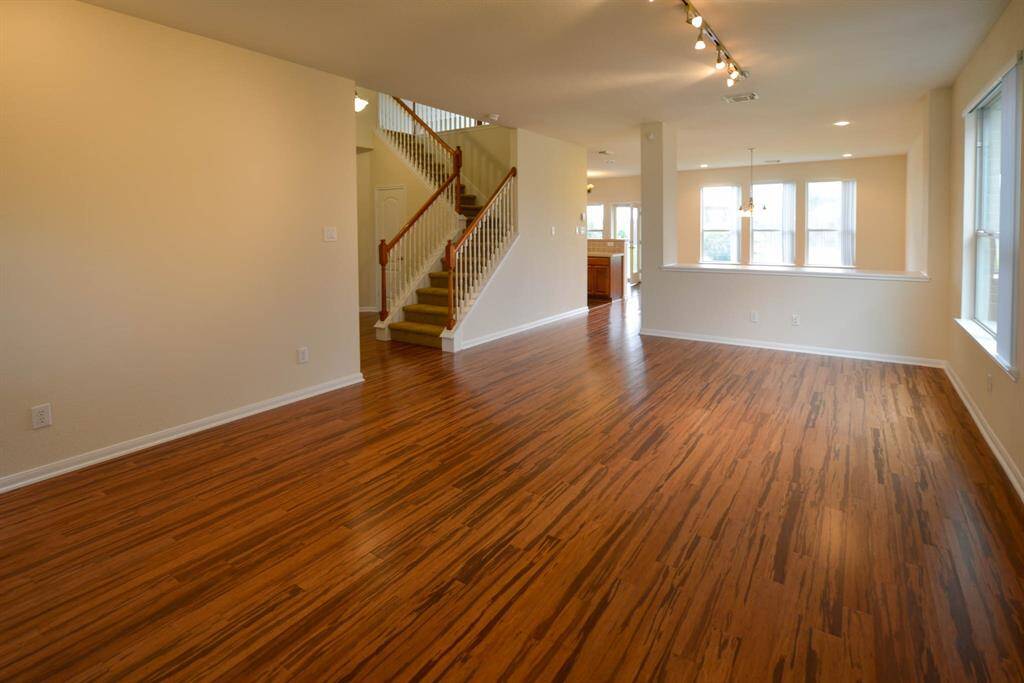 Elegant bamboo flooring flows seamlessly throughout the downstairs.