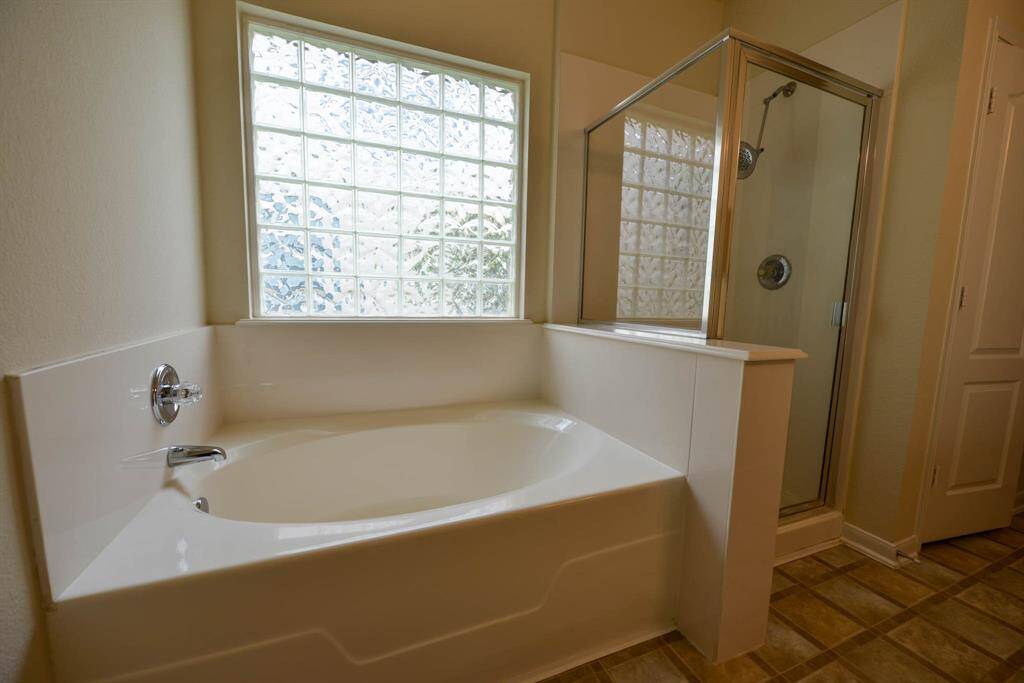 Indulge in the luxury of the owner's bath, featuring both a garden tub and a shower for your relaxation.