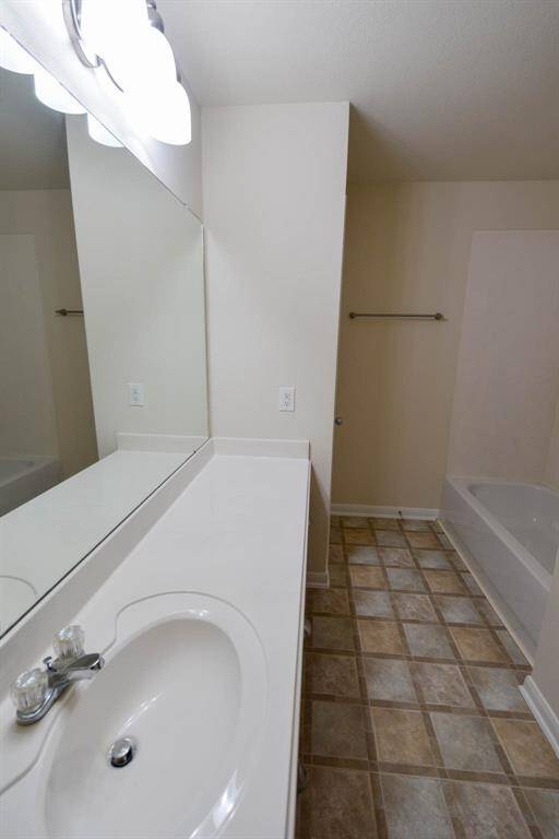 Spacious hall bath with extended counter, conveniently accessible from all upstairs rooms.