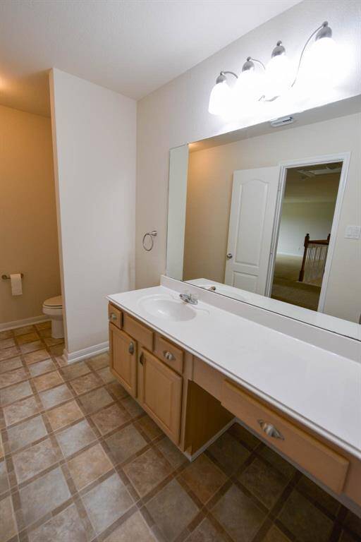 Bright vanity lighting enhances the hall bath.