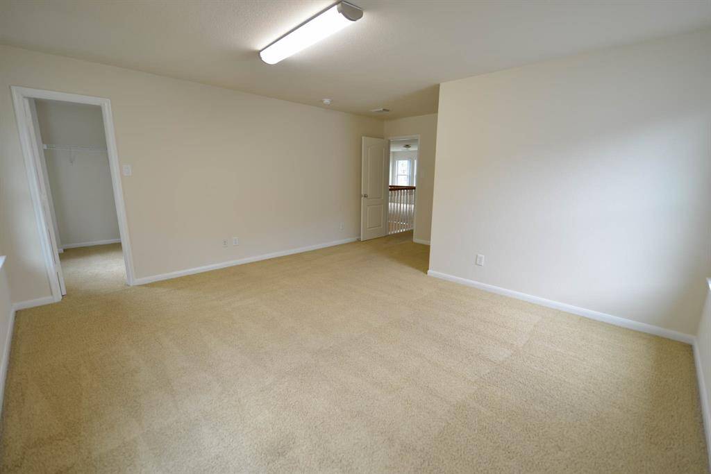 Expansive bedroom with a walk-in closet, perfectly situated at the front of the home for enhanced privacy.