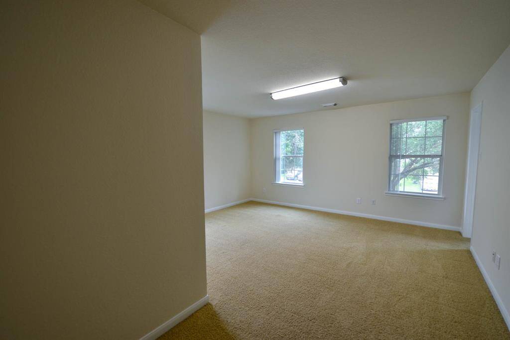 Spacious bedroom with abundant natural and artificial light.