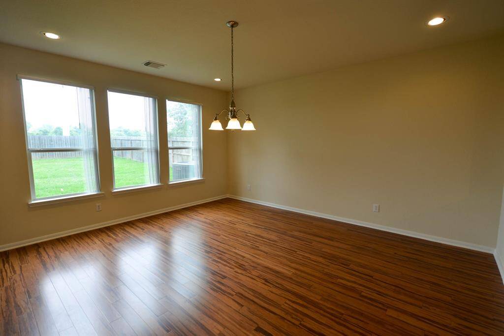 Stunning bamboo floors and a bright, sunny view of the yard from the dining and living area.