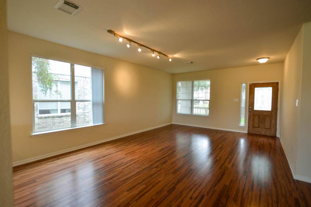 Step into the spacious family room featuring elegant bamboo flooring.
