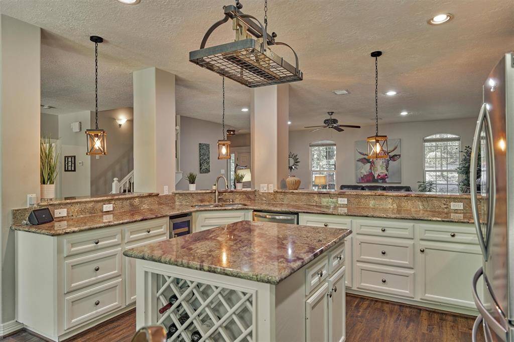 The center island offers a wine rack, storage, and electrical outlet.