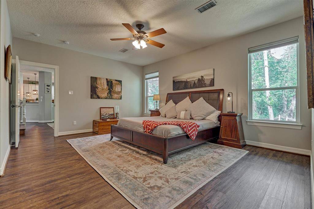 The primary suite with lots of natural light overlooks the back yard.