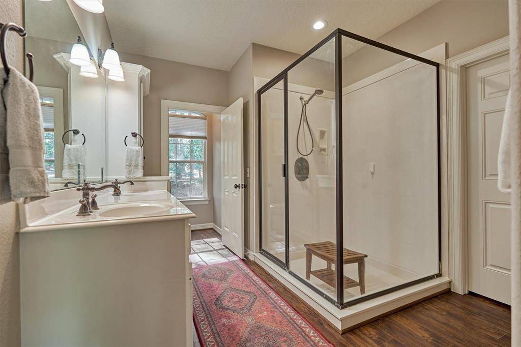 The primary bath has dual sinks, a private water closet, and large shower.