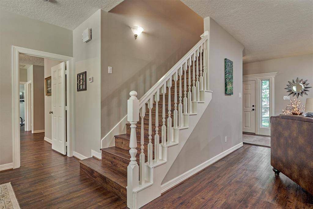 The main staircase leads to two identical bedrooms, each with their own ensuite bath.