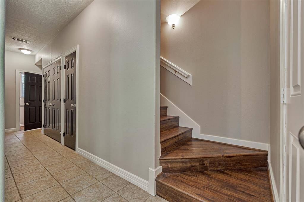The back staircase leads to a large room with additional bathroom