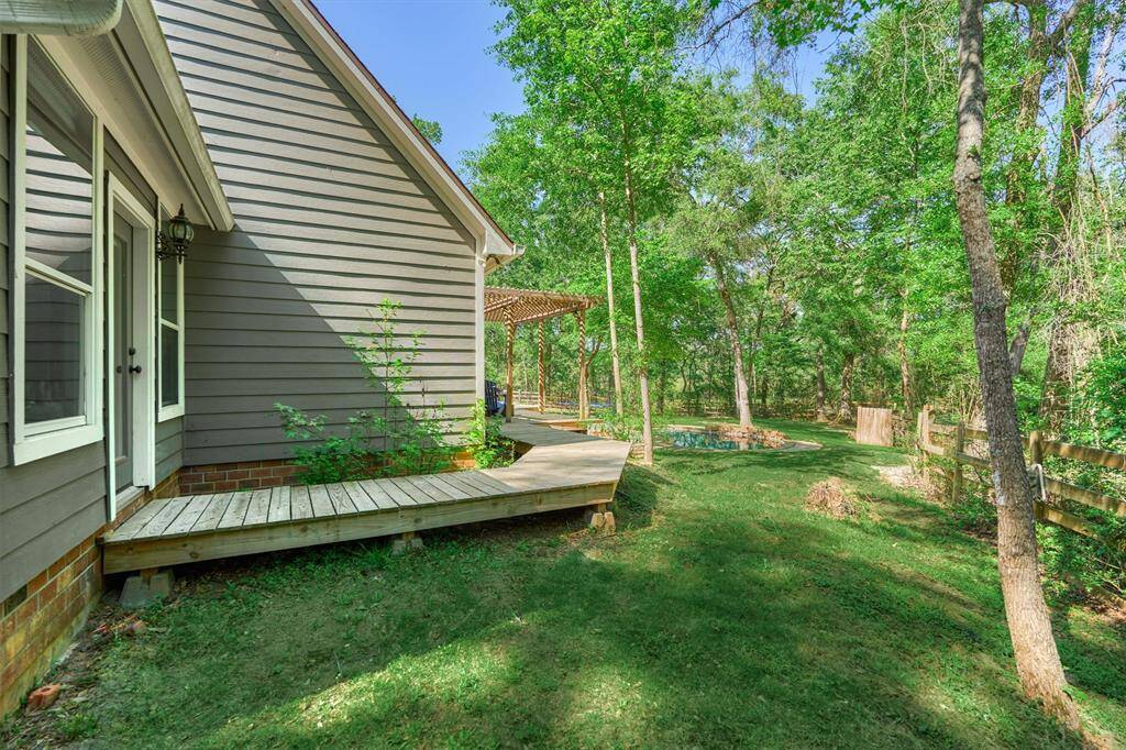 This shows the door from the room attached to primary suite, which leads to the back deck and pool beyond.