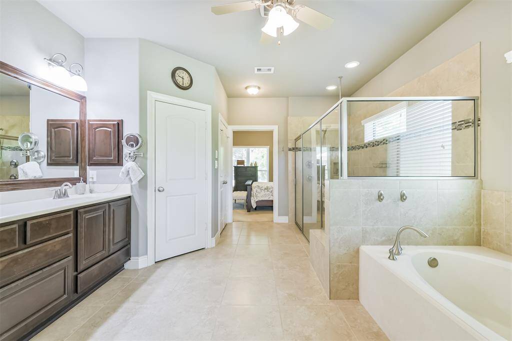 What more can I say about the en suite bathroom? In addition to the standard sinks, this luxury bathroom includes a jetted soaking tub, a massive shower with a bench seat and double shower heads, and a private toilet closet with even more storage. What is there not to love about this bathroom?