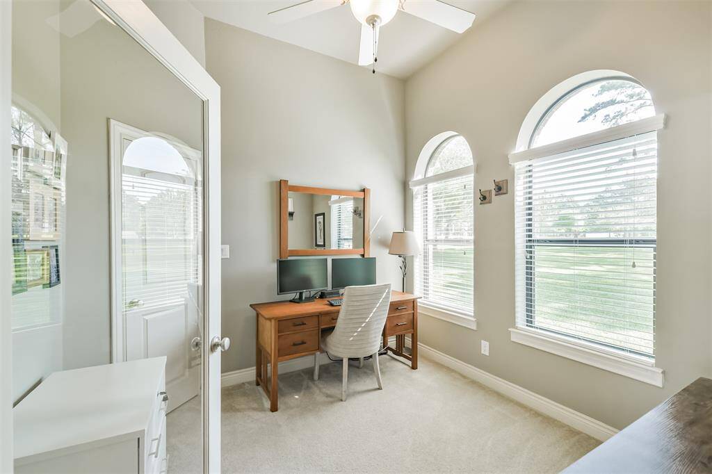 This versatile room features elegant French door and soaring ceilings, making it an ideal home office or flex space. Arched windows allow for abundant natural light and offer beautiful views of the manicured front lawn.