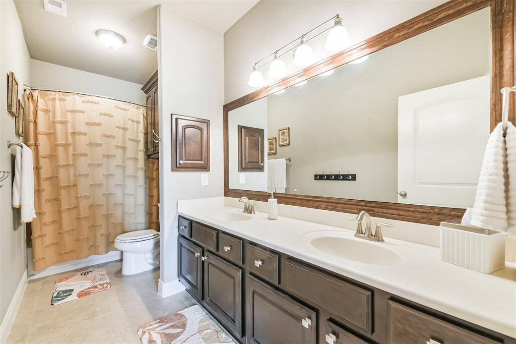 The nearby full bath is beautifully appointed with sleek finishes and thoughtful touches. Featuring a spacious vanity, elegant lighting, and a tub/shower combo, it offers both style and functionality. Ideal for guests or family, this bathroom is designed to feel fresh, bright, and welcoming.