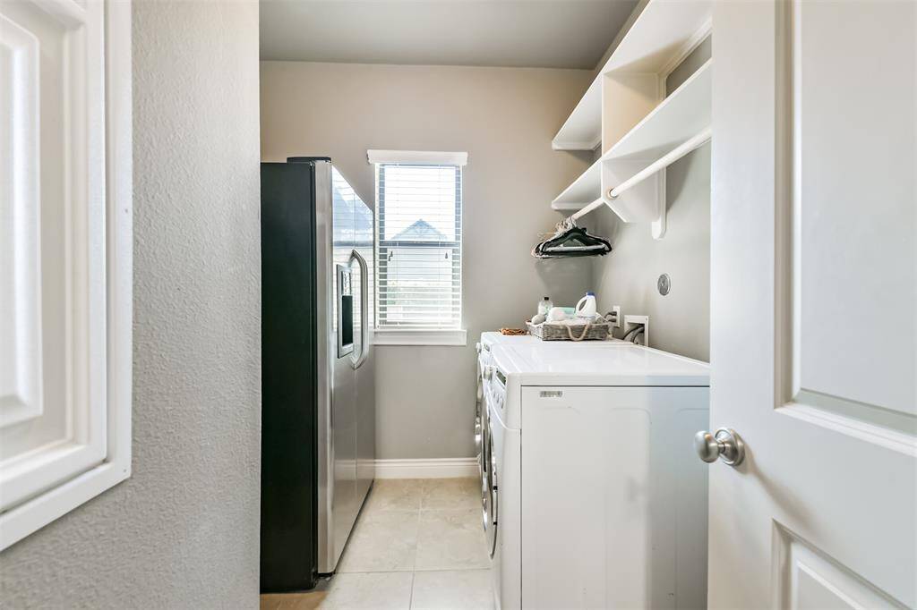Functional and stylish, this laundry and mudroom combo features built-in cubbies, hanging space, and a drop zone for daily essentials. The nearby desk nook adds the perfect touch for staying organized or managing household tasks.