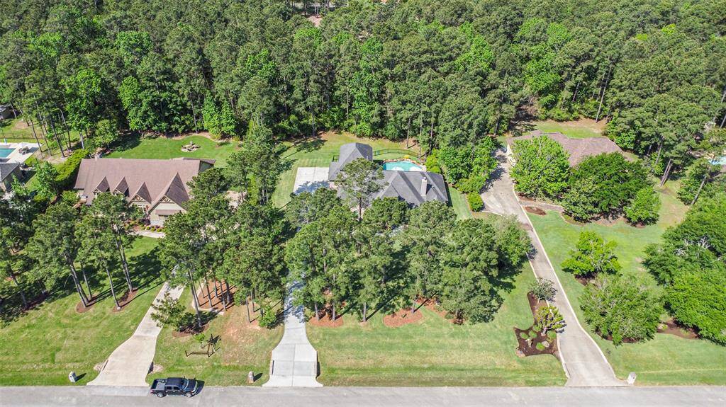 Nestled on a spacious, tree-lined lot, this home offers privacy and tranquility in a picturesque setting. Surrounded by lush greenery and set back from the street with a long, welcoming driveway, the property provides a peaceful retreat while still being part of a beautiful, well-maintained neighborhood. A rare blend of space, serenity, and curb appeal!