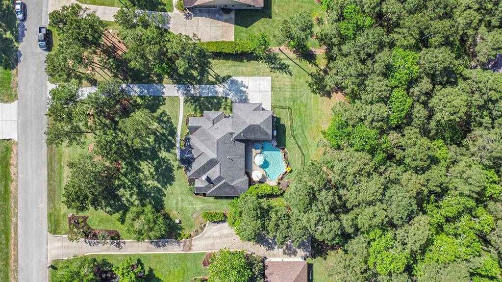 Nestled on a spacious, wooded lot, this stunning home offers the perfect blend of privacy and luxury. Surrounded by mature trees, the property features a beautifully landscaped backyard with a sparkling pool and spa—ideal for relaxing or entertaining.