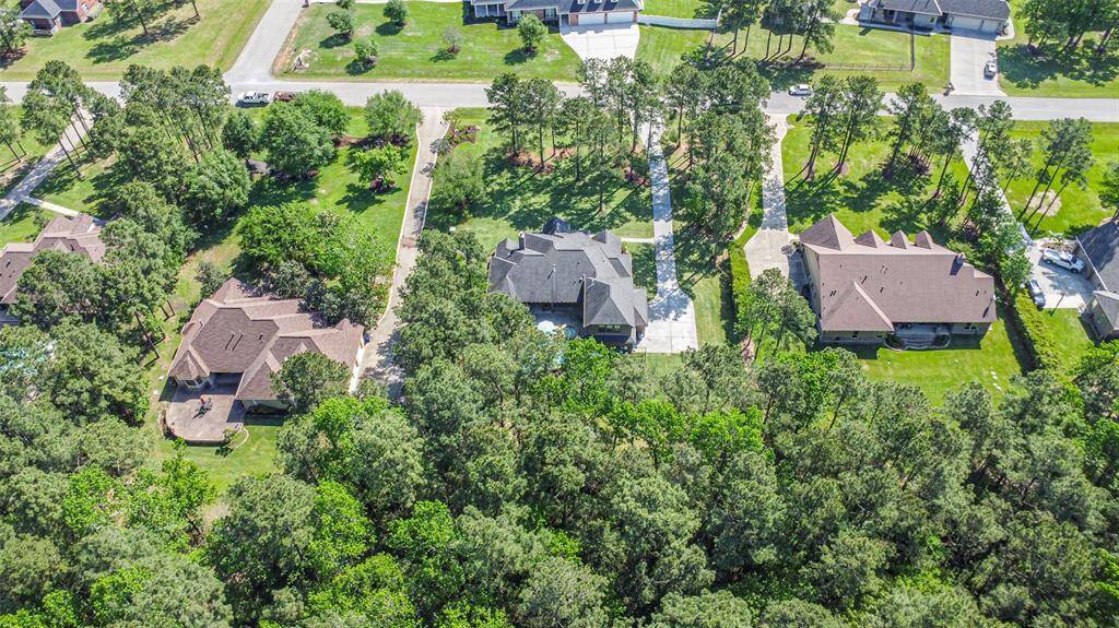 Enjoy peaceful privacy and serene views from this beautifully positioned home on a spacious, wooded lot. The long private driveway, lush landscaping, and ample space between neighboring homes create the perfect setting for quiet living while still being close to everything.