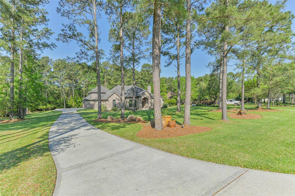 Set on a spacious, tree-filled lot, this home offers a serene setting and beautiful curb appeal. The long, curved driveway adds a grand welcome and plenty of space for guest parking.