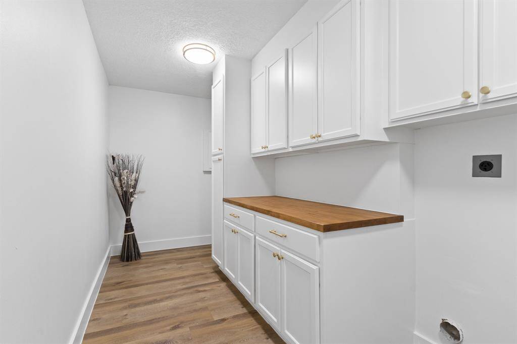 Extra large utility room with plenty of cabinets for extra storage and countertop to fold your clothes ect...
