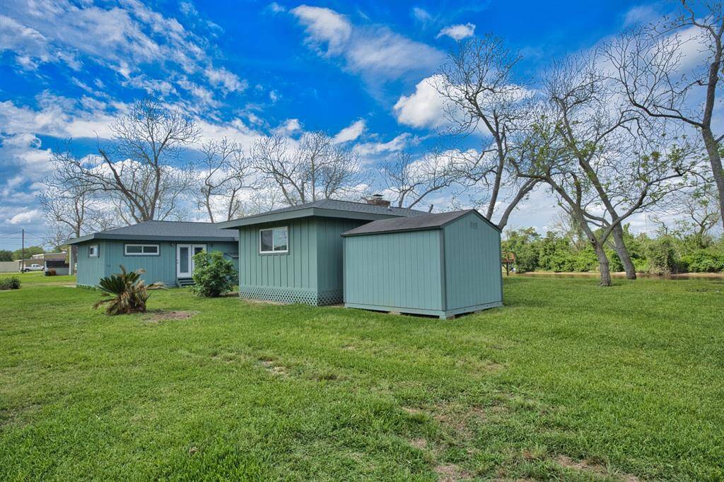 Right side of the home with a Storage Building