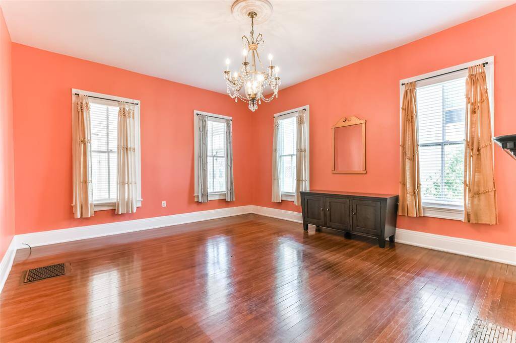 Discover the spacious front living/ dining area, the second of two with pocket doors and fireplace. This inviting space flows seamlessly into a convenient butler's pantry and well-appointed kitchen.