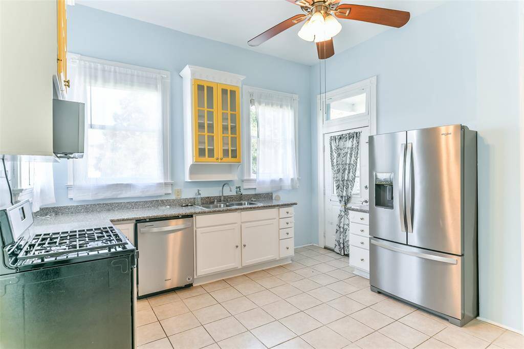 Spacious kitchen featuring a gas stove, ample natural light, and direct access to the backyard deck which overlooks the backyard.