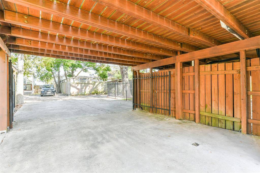 Carport at the end of the long driveway allowing for tons of off-street parking and accessible from Avenue O and the back alley making parking simple.