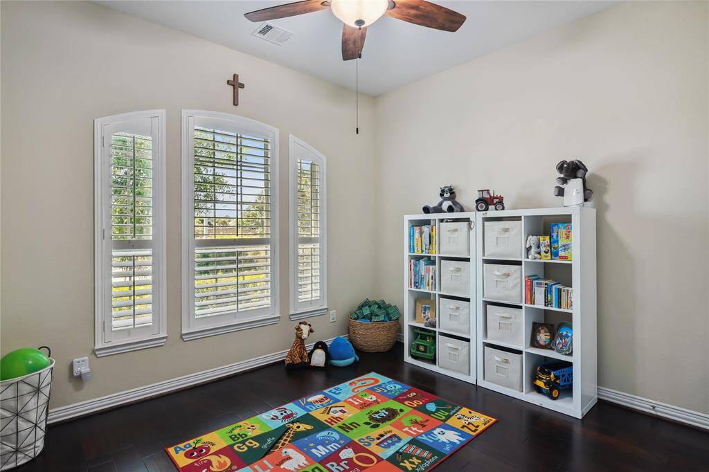 Downstairs Kids Bedroom/Playroom with large closet and plantation shutters.