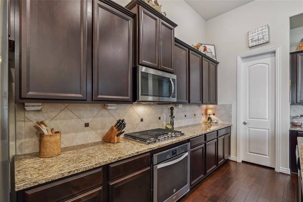 The kitchen boasts high-end amenities, including a gas stove and stainless-steel appliances.