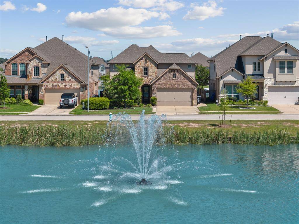 Tons of curb appeal on this lovely entertainer's dream home! Sprinkler system front and back.