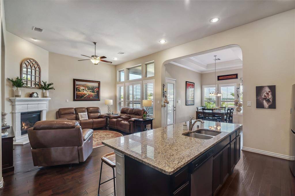 Living Area with soaring ceilings, fireplace, large windows and open to the luxury Kitchen.