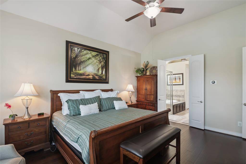 This custom primary bedroom has a high ceiling, giving the suite a spacious and open feel. You’ll feel like a king in it.