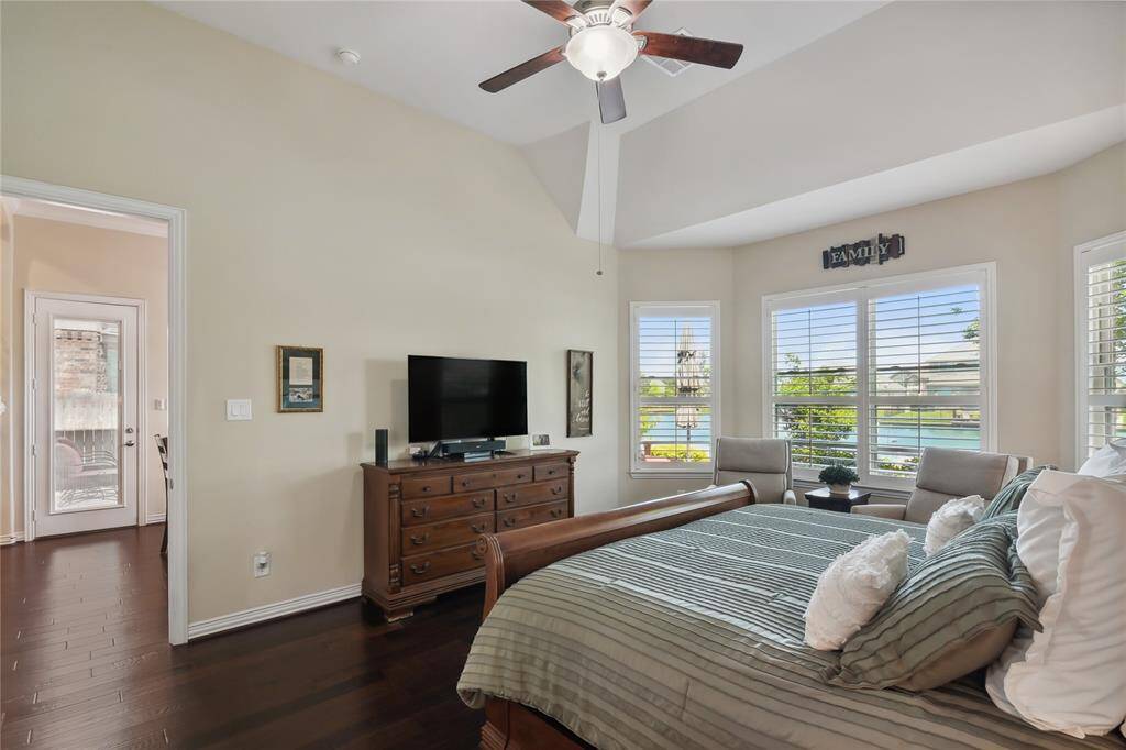 This Primary Bedroom looking over the water through custom bay windows and plantation shutters.