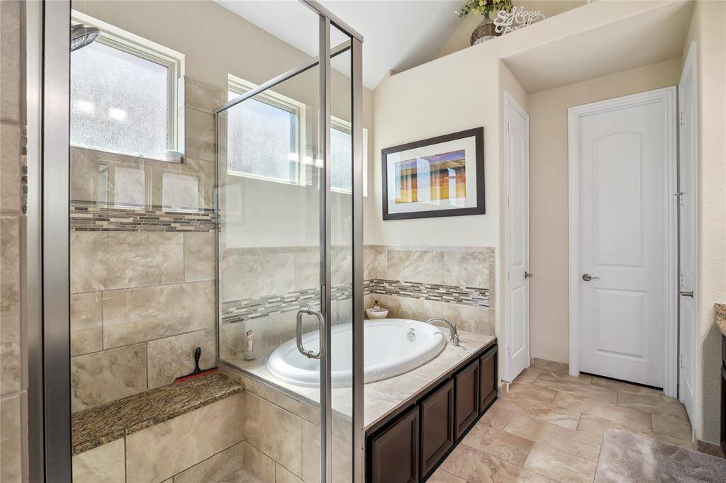 Large oversized shower with seat, dual sinks with knee space, linen closet and large soaking tub.