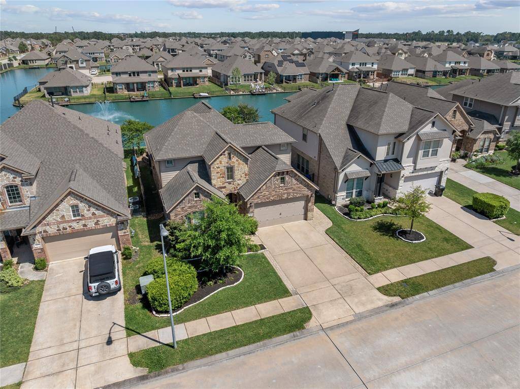 Beautiful Aerial Shot of Front of Home with lake views in front and back.