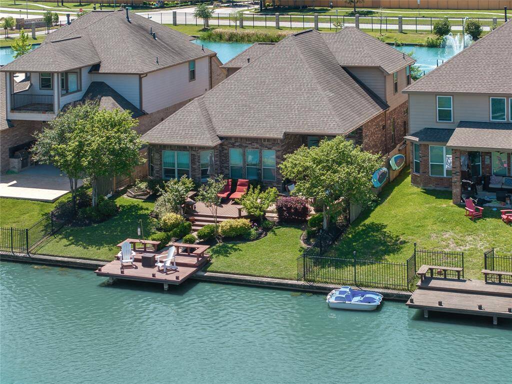 Aerial Shot of Backyard with custom pier, trek deck, professional landscaping and fire pit sitting area.