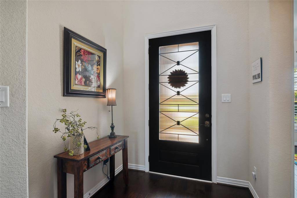 Stunning entrance with wood floors and soaring ceilings.