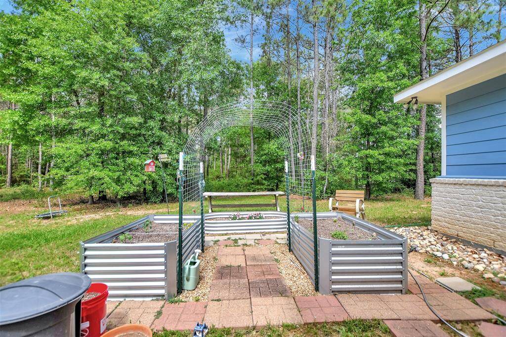 The backyard offers plenty of space for gardening.