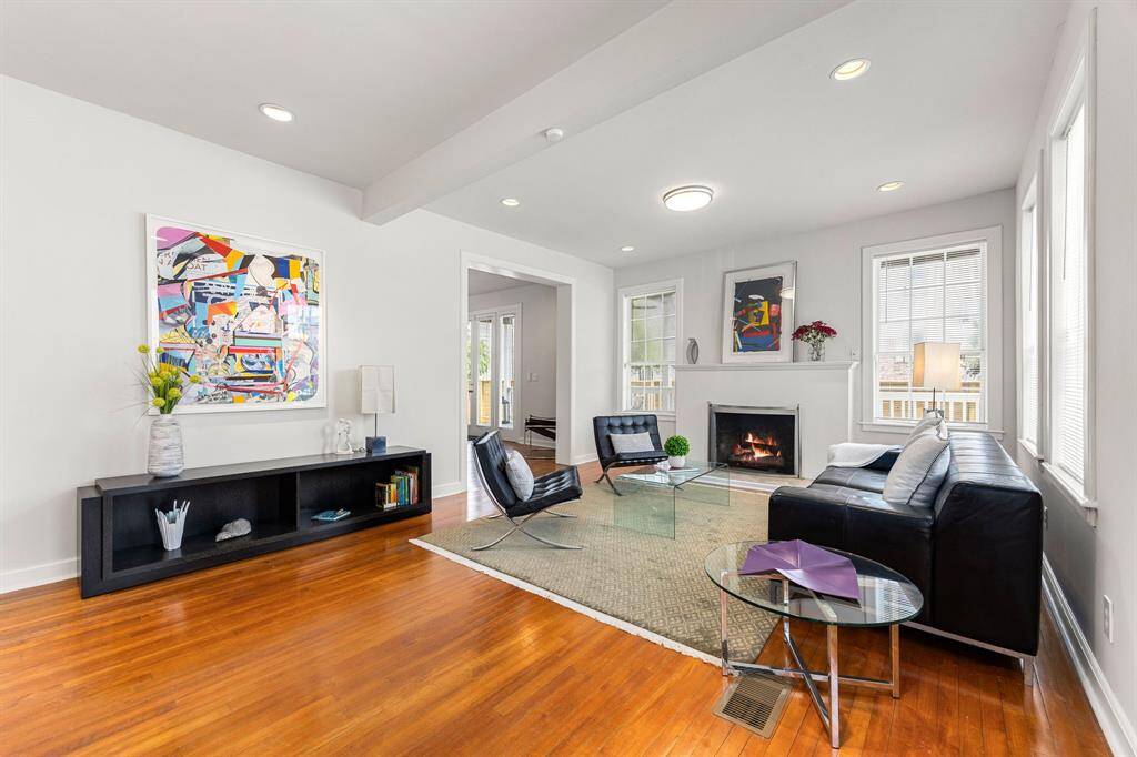 Inside the main living area you will find hard wood floors, a wood-burning fireplace and ample windows with tons of natural light flowing through.