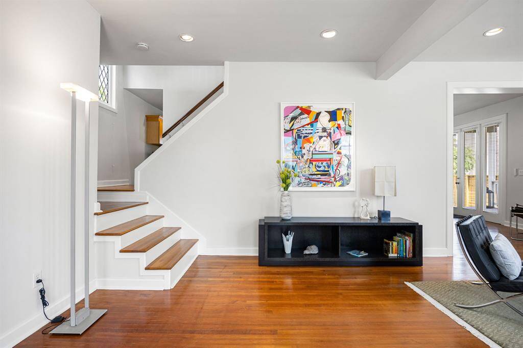The welcoming entryway showcases a striking split staircase that leads to the upper level.