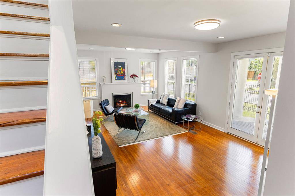 Charming home offers crisp white walls and gleaming hardwood flooring original to the home.