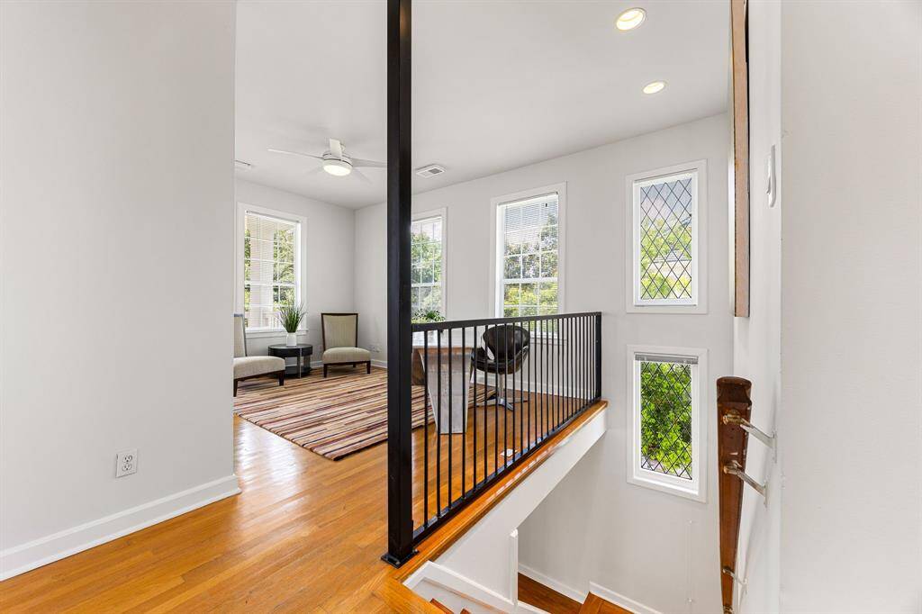 At the top of the stairs, you'll find a versatile space ideal for a home office or can be converted to a bedroom. This space does have a large closet along with a patio access facing the front of the home.