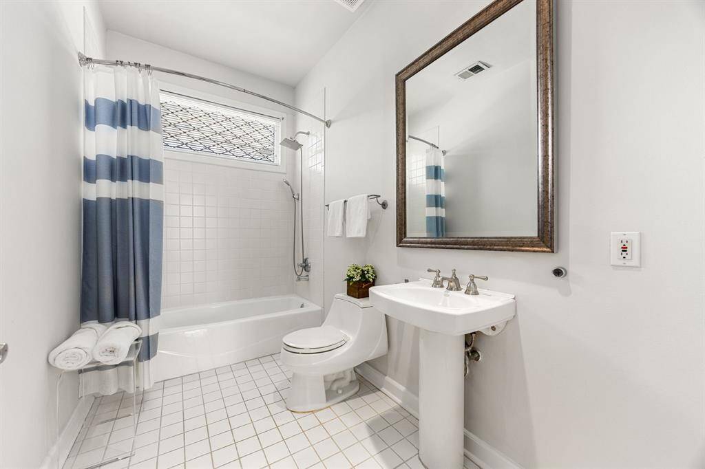 Charming secondary bathroom upstairs has plenty of space to customize along with clean white lines with natural light flowing in.