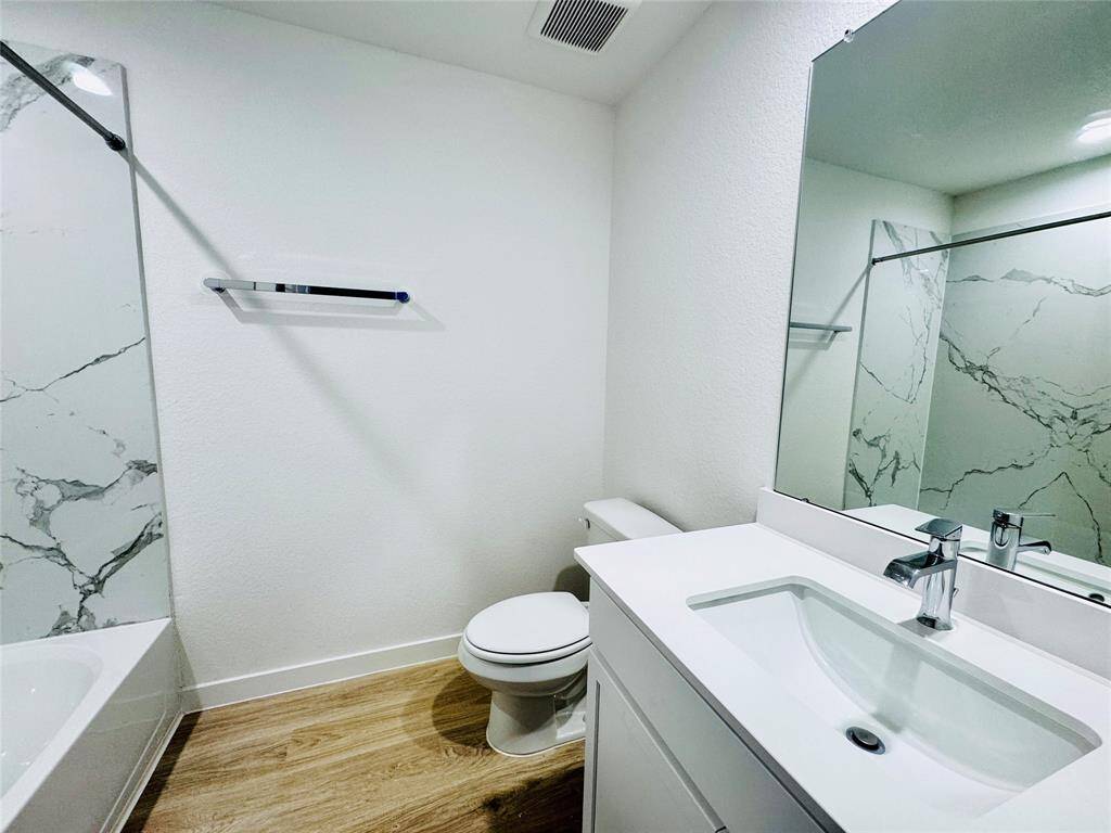 Spacious third full bathroom with elegant finishes.