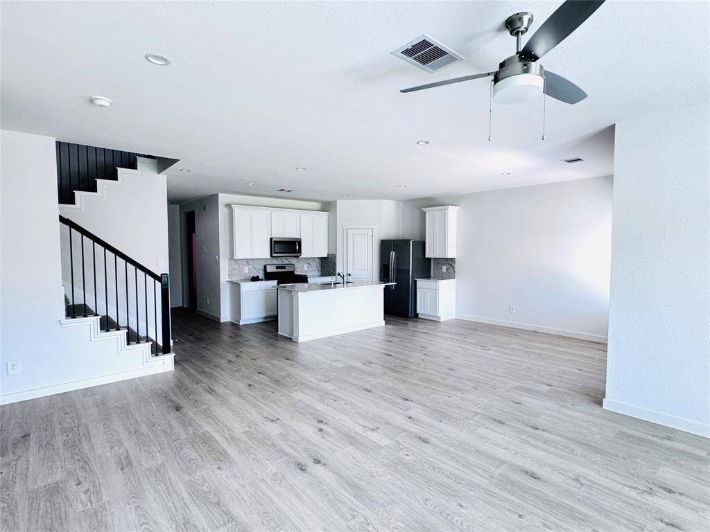 Spacious open-concept living area seamlessly integrates the kitchen and dining space, perfect for modern living.