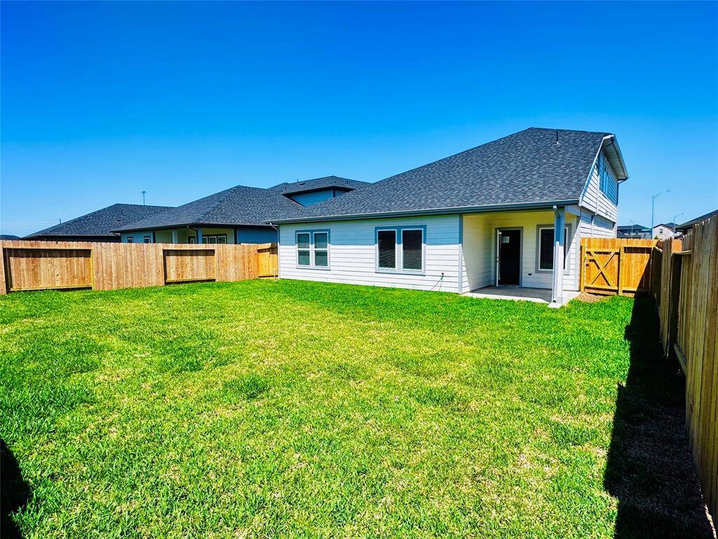 Expansive backyard ideal for activities and relaxation, featuring a covered patio perfect for entertaining and enjoying the Texas weather.